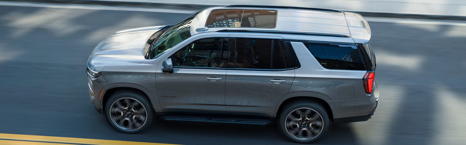 2027 Chevrolet Tahoe silver overhead driving shot