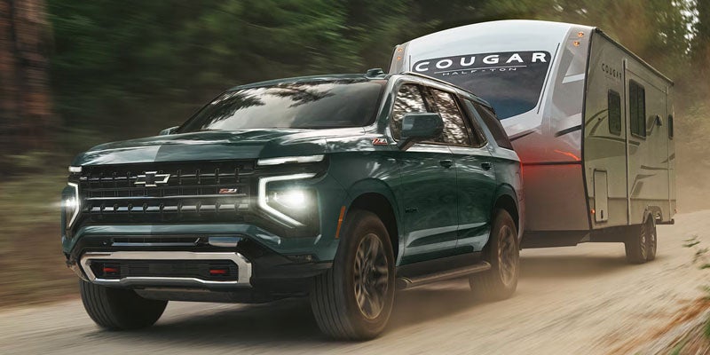 2027 Chevrolet Tahoe towing a travel trailer